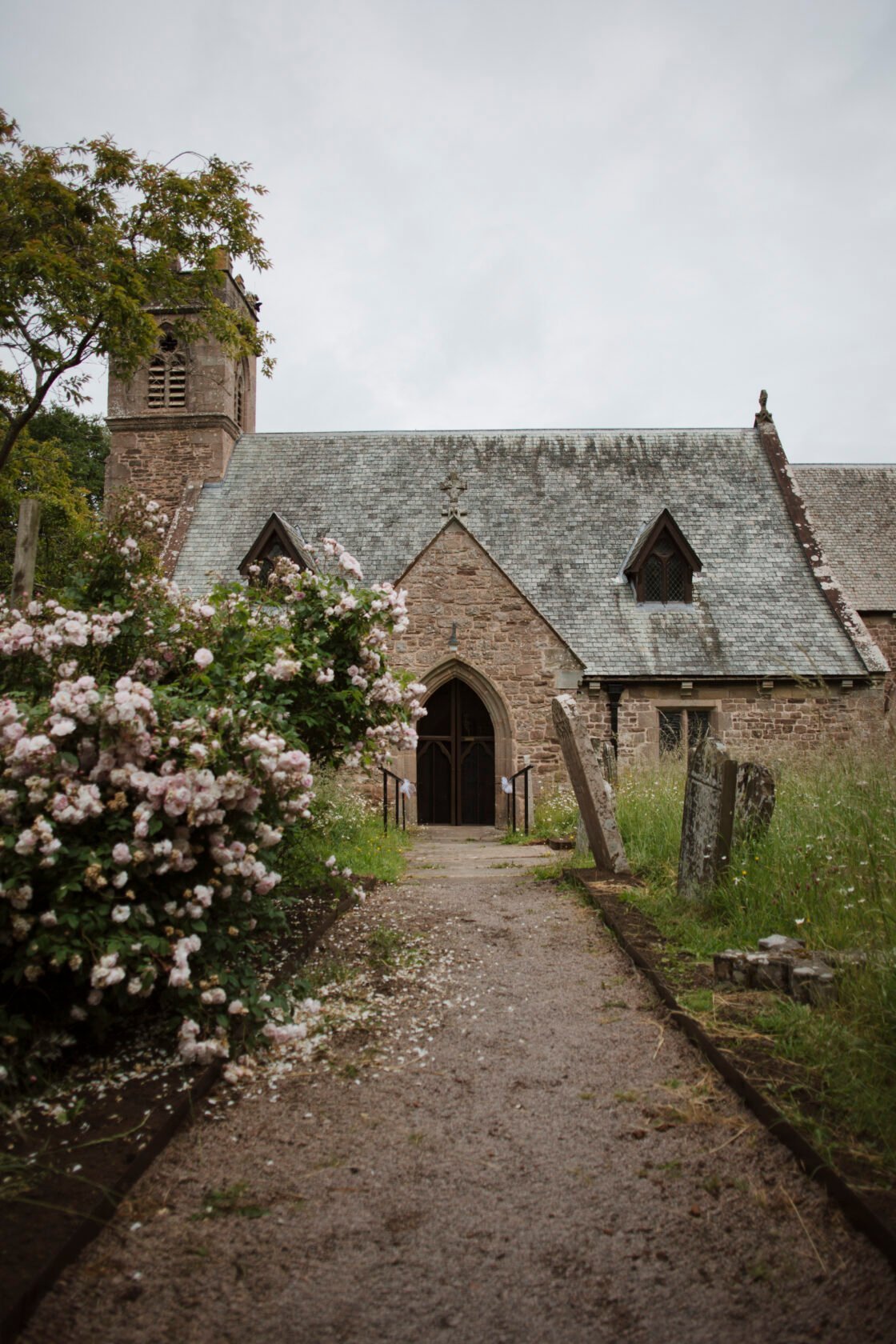 Stone church entrance surrounded by countryside near Llandrindod Wells