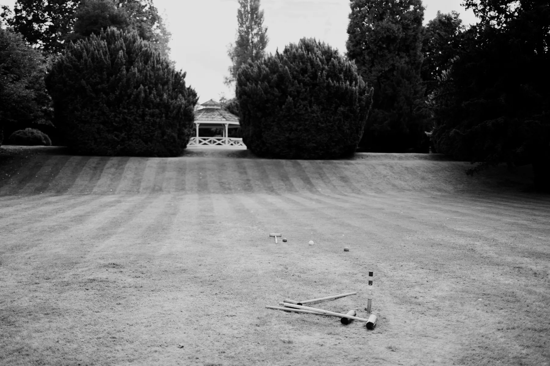 Croquet game set out on the lawn at Clearwell Castle in black and white