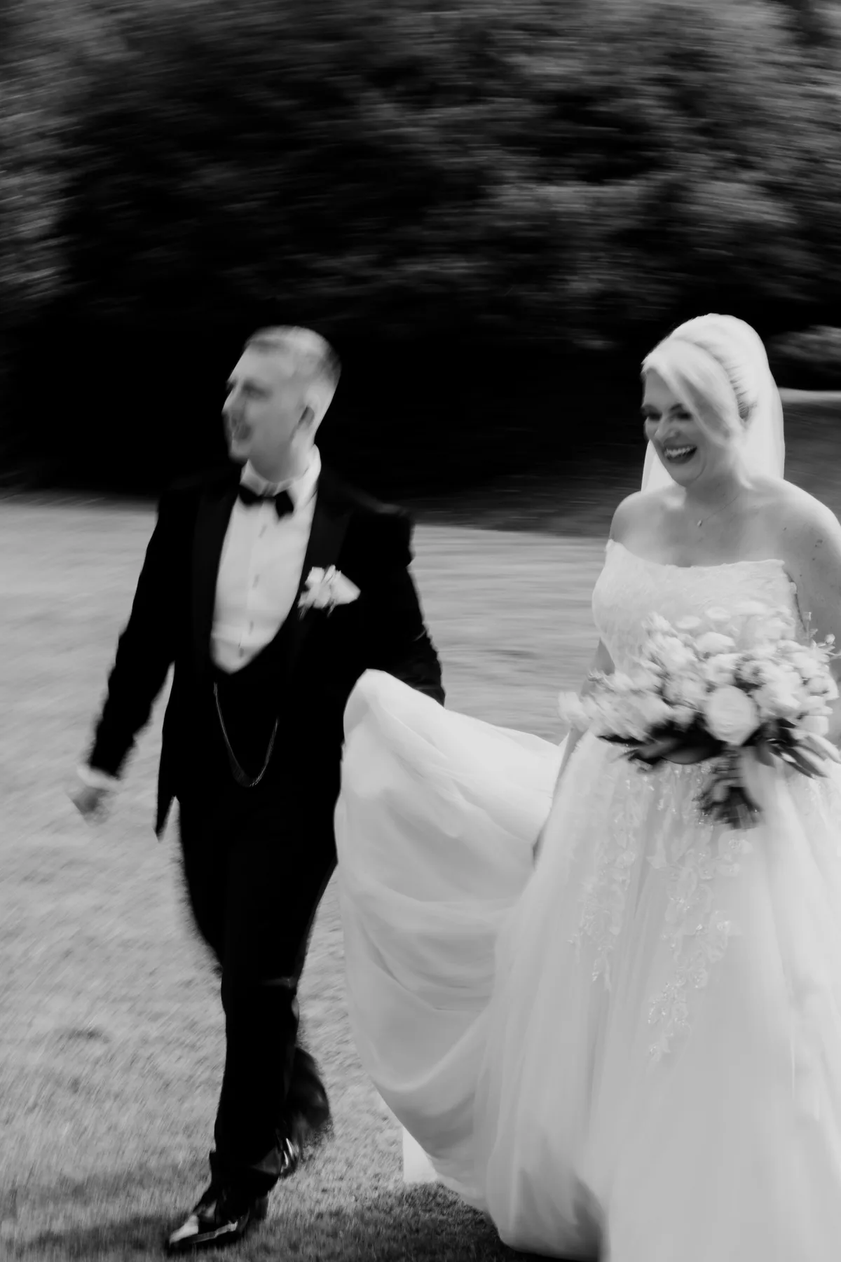 Emily and David laughing together in an artistic black-and-white portrait