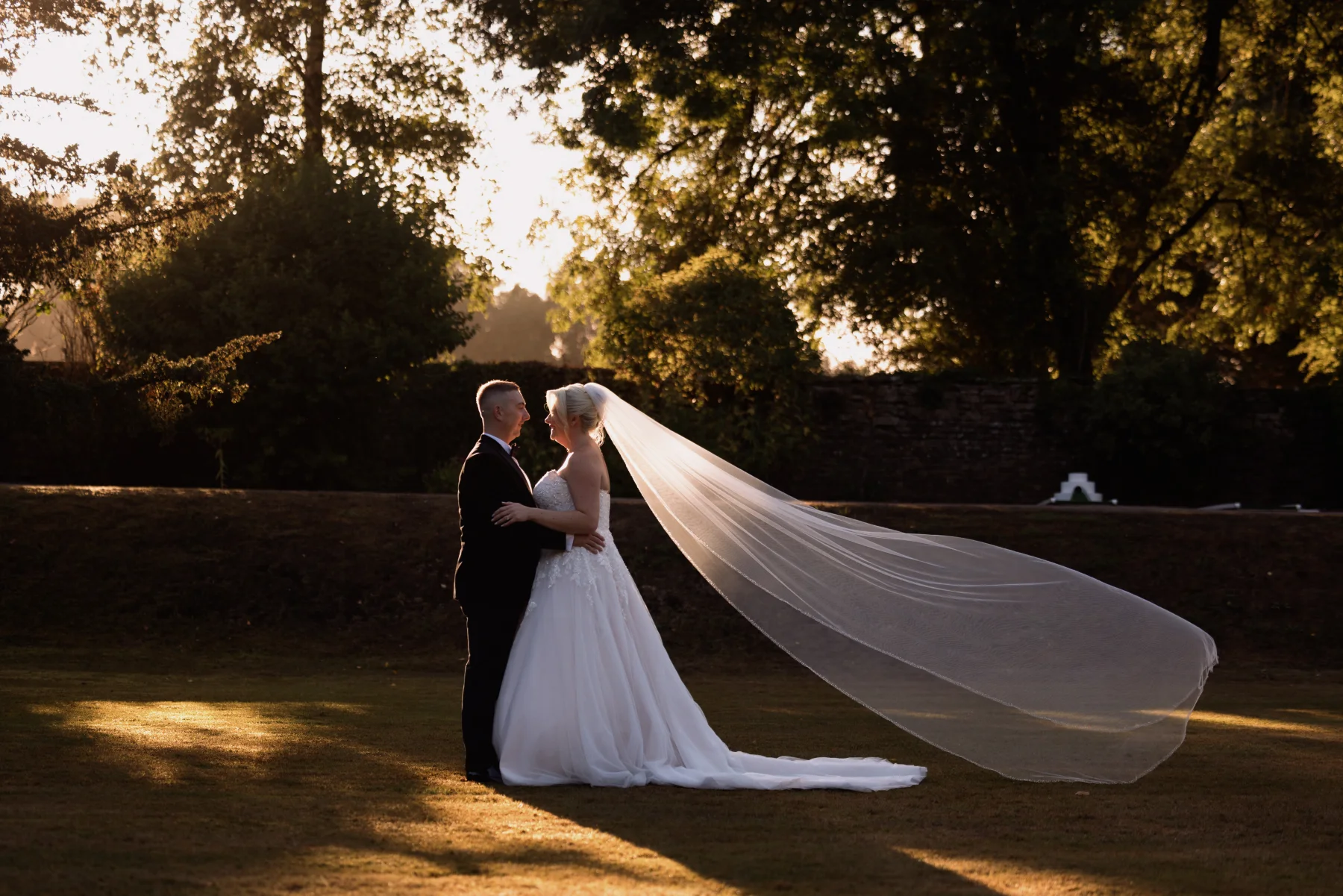 Emily and David together at golden hour during their Clearwell Castle wedding