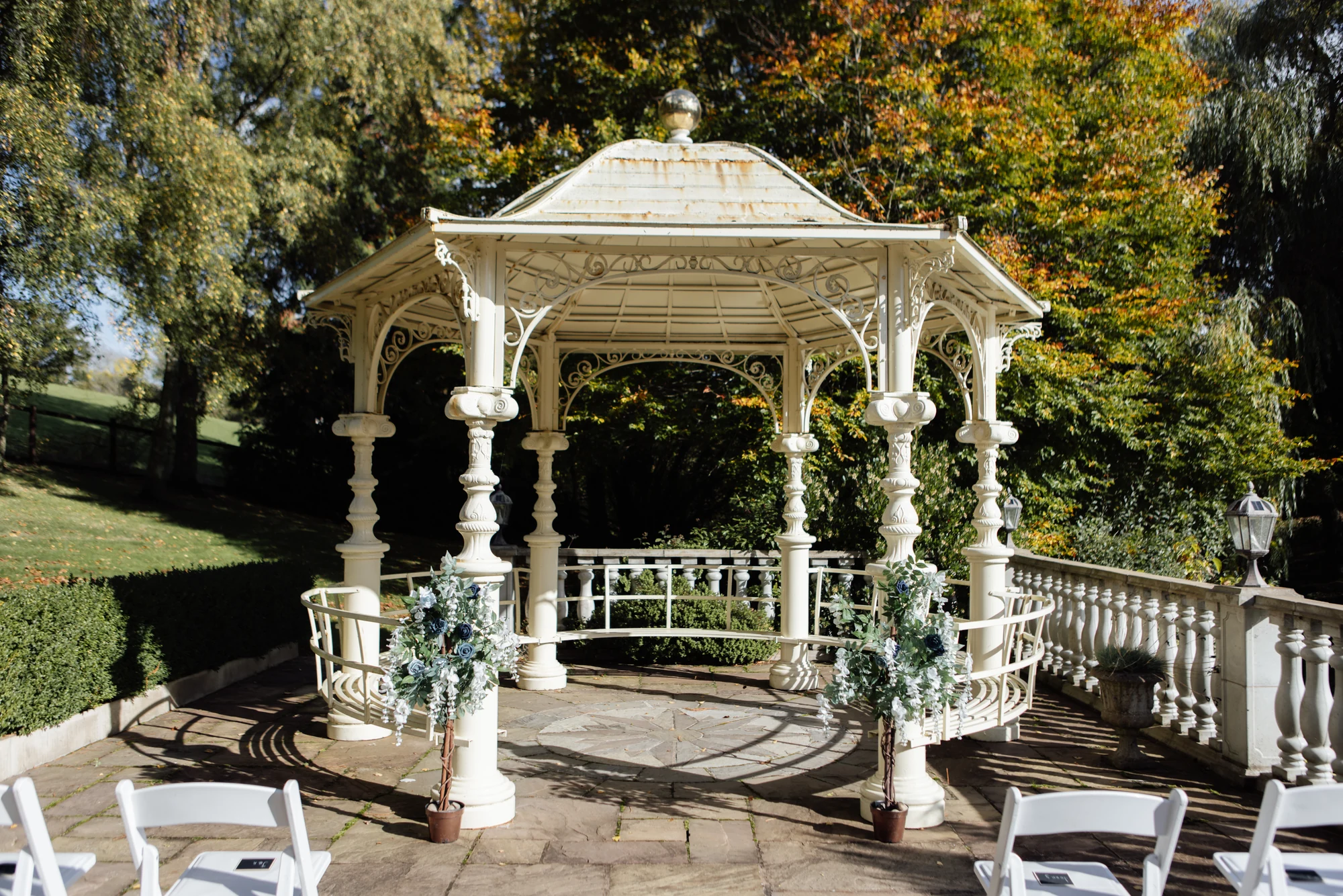 The cream rotunda at Highgate Cottages, decorated with flowers and surrounded by trees