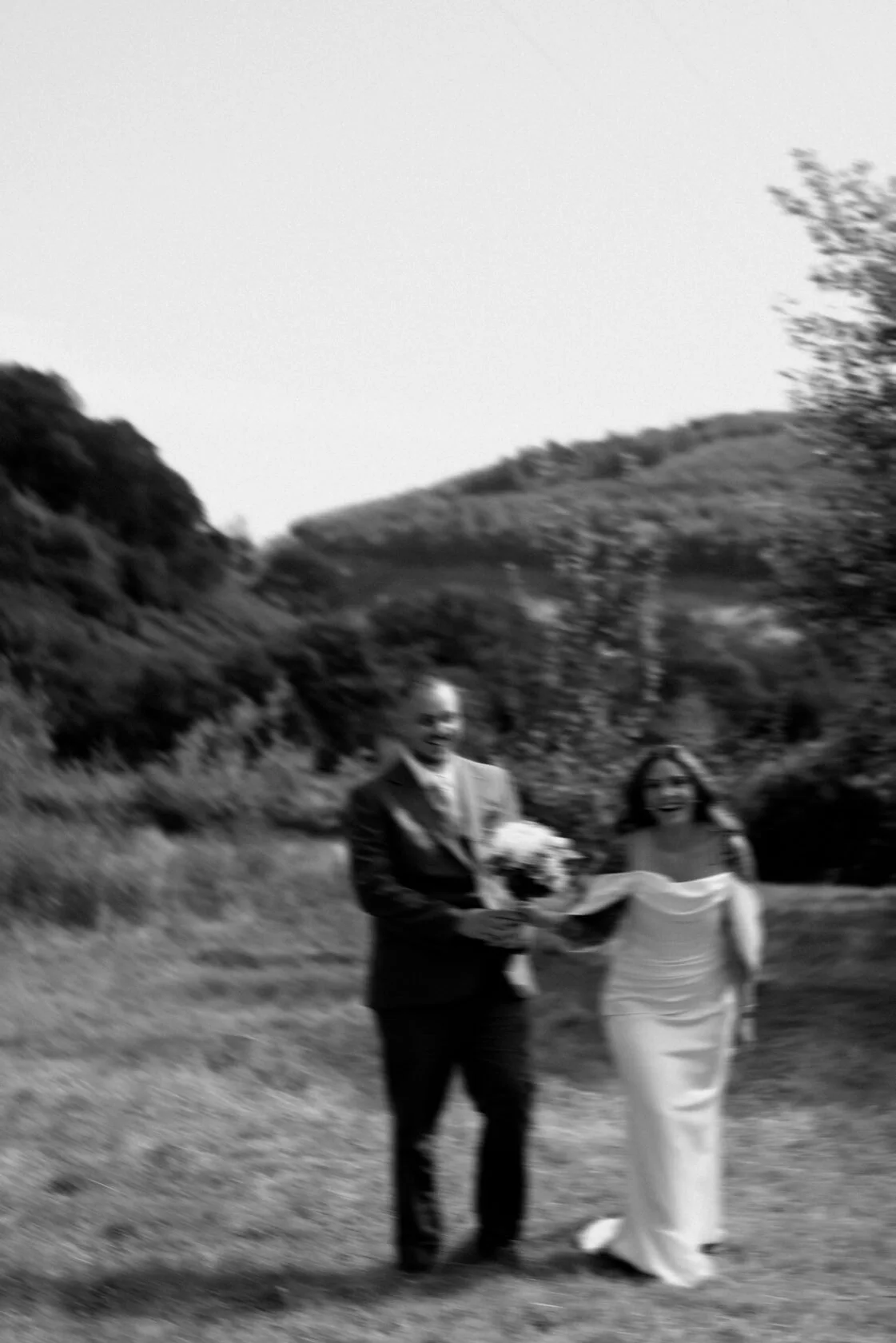 Artistic portrait of newlyweds beside an Elan Valley reservoir