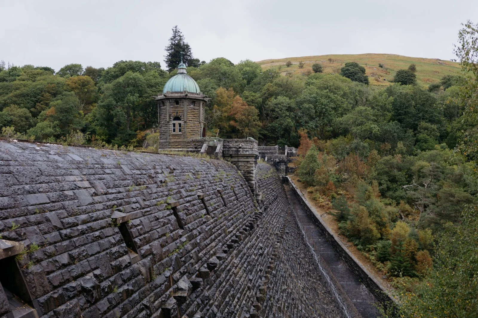 Historic stone dam and round tower surrounded by Elan Valley hills