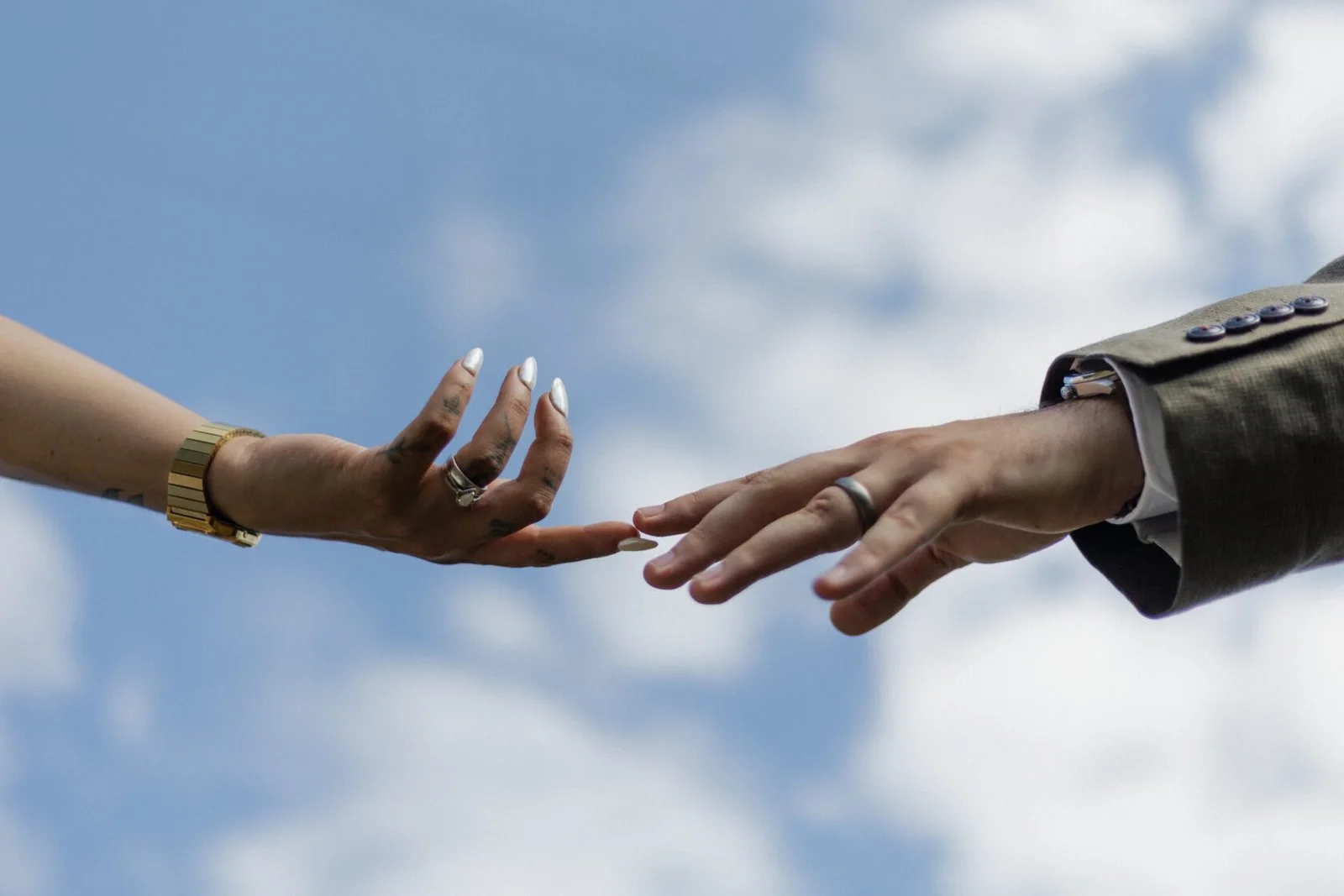 Close-up photograph of a couple exchanging rings