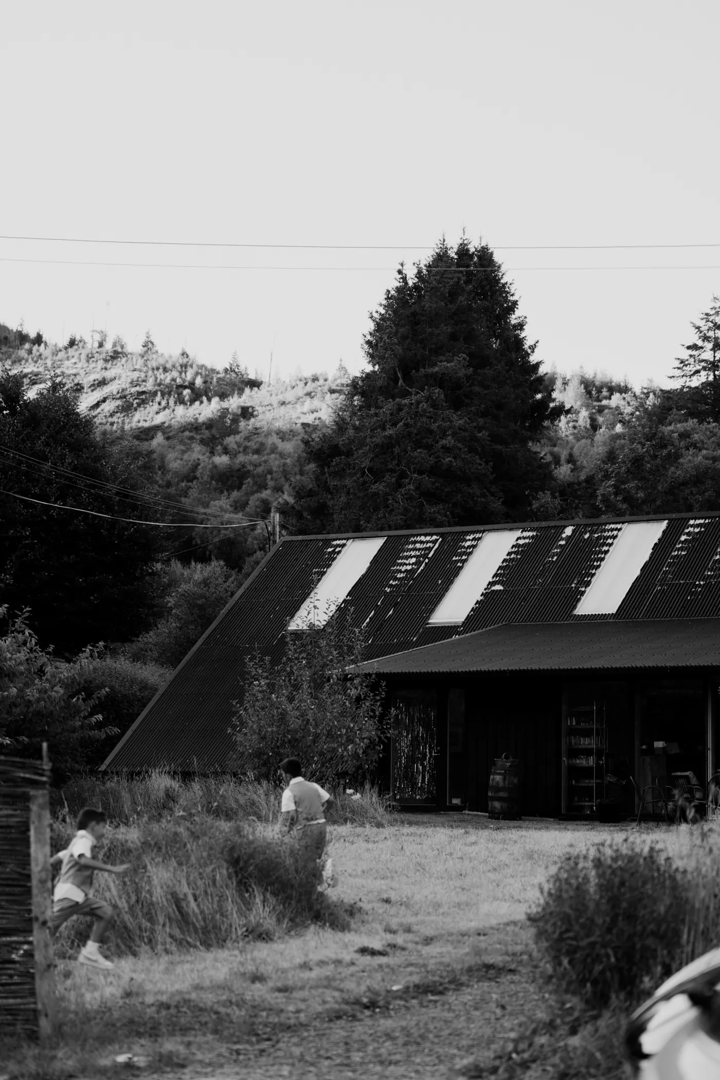 Black-and-white view of Nant y Walch Barn and the surrounding Mid Wales landscape