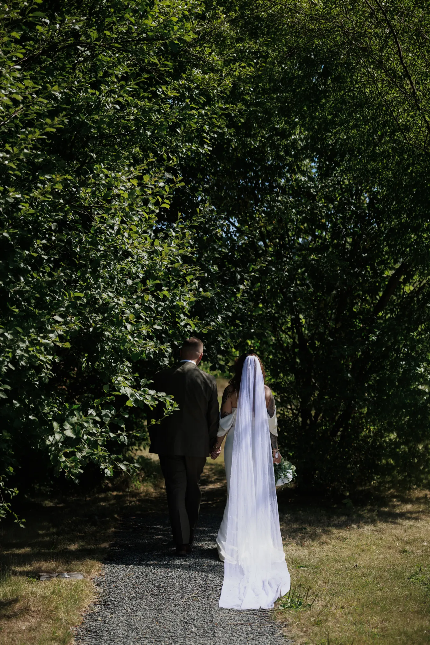 Autumn and Sebastian walking together into woodland at Nant y Walch Barn