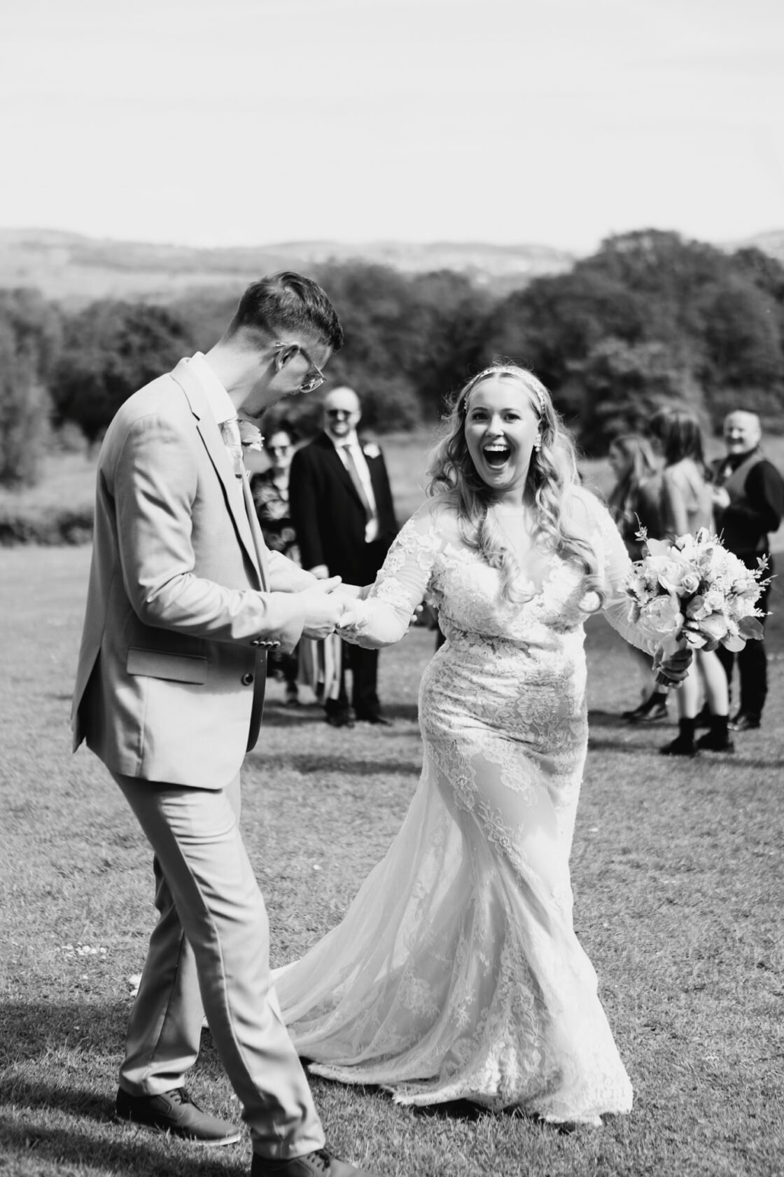 Newlyweds laughing naturally together in black and white