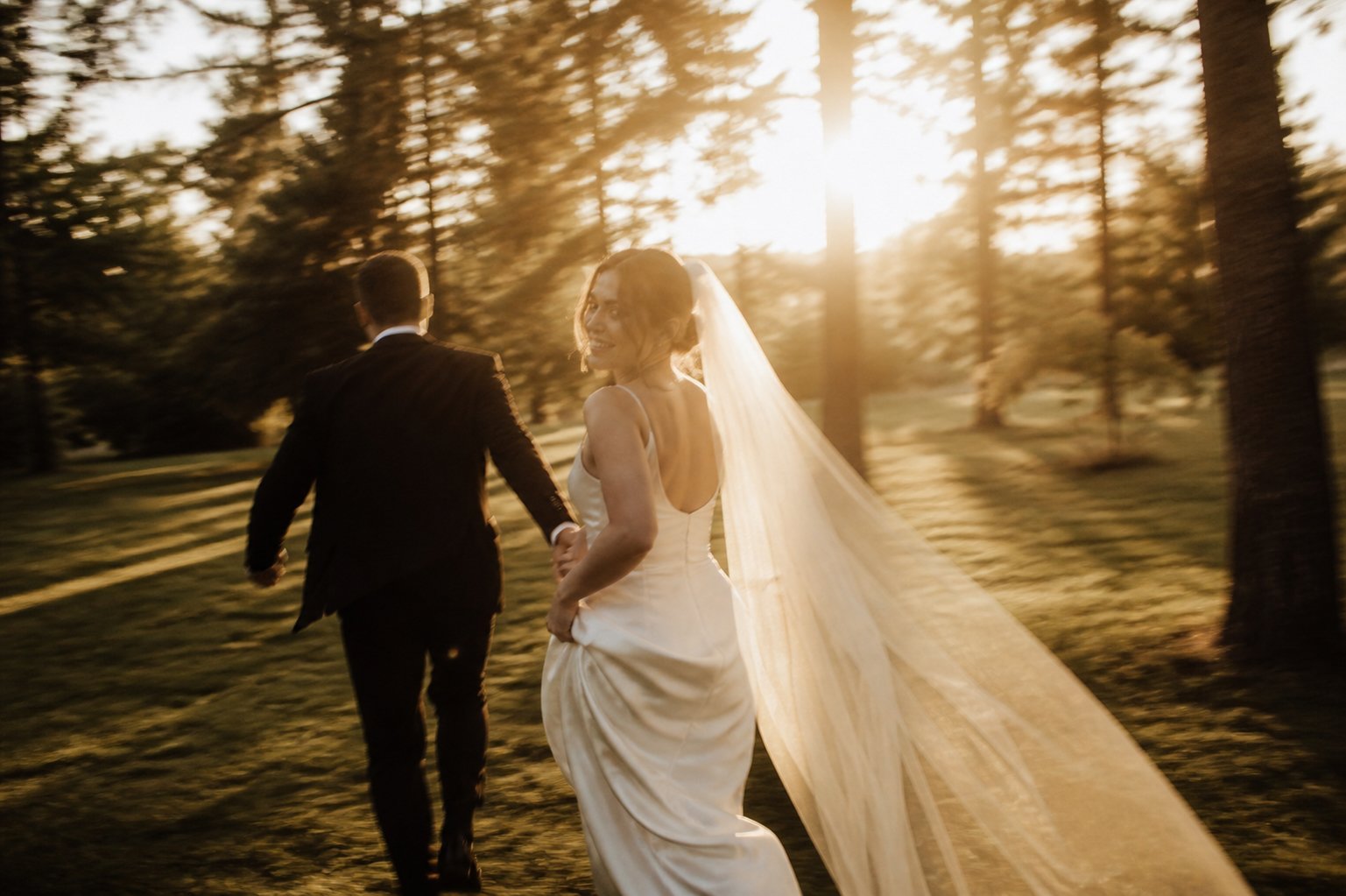 Couple walking through warm evening light in Wales