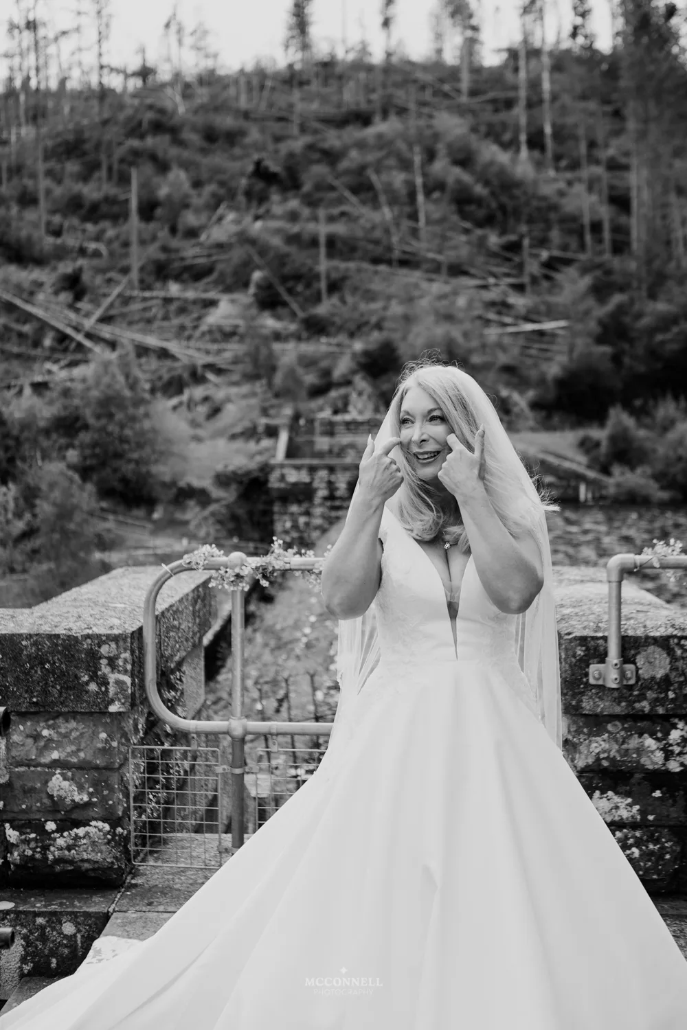 Debi laughing and wiping away a happy tear during her Pen y Garreg Dam wedding